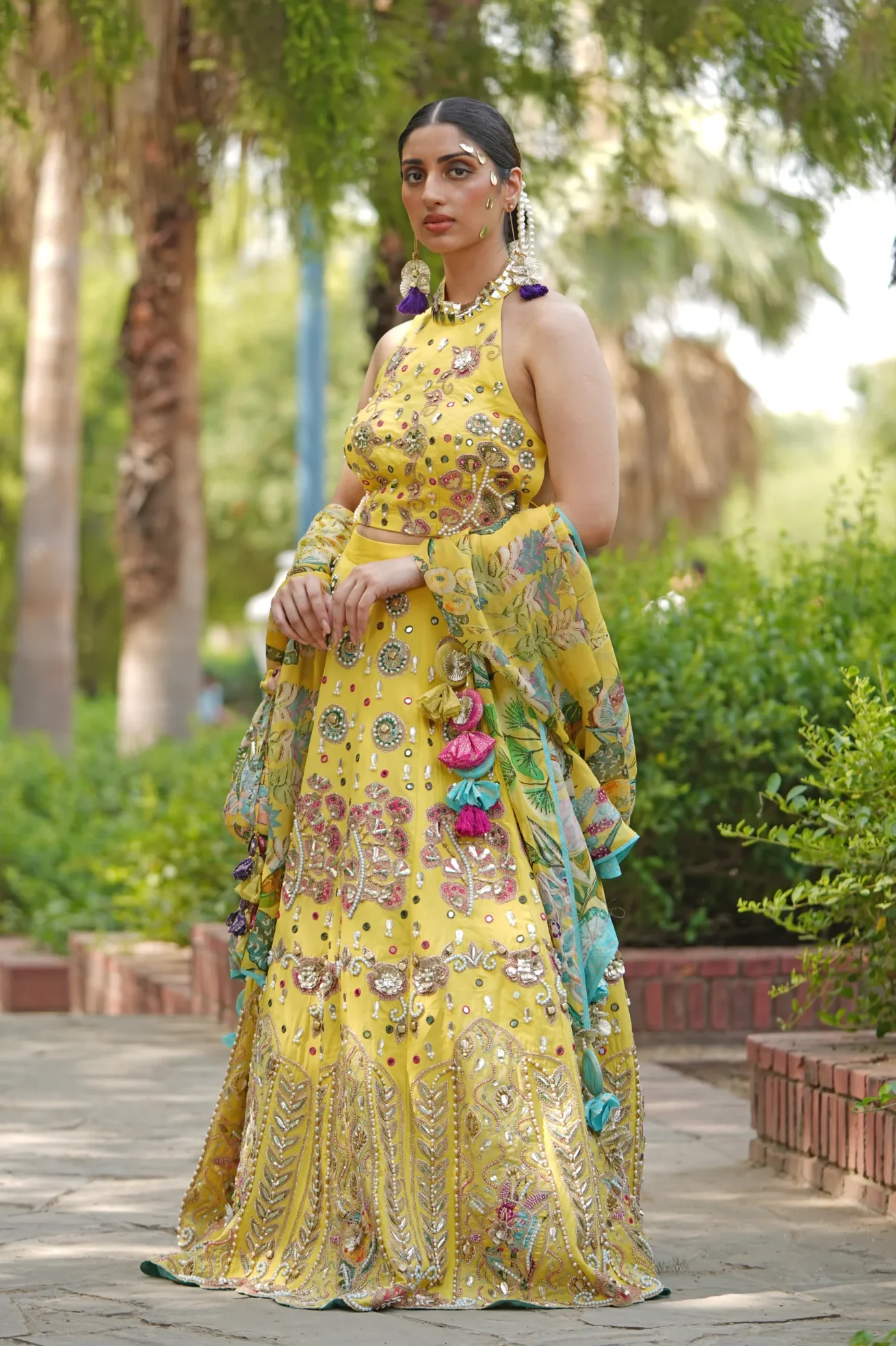 Yellow embroidered lehenga with halter blouse and dupatta from Golden Muslin By Soniya G