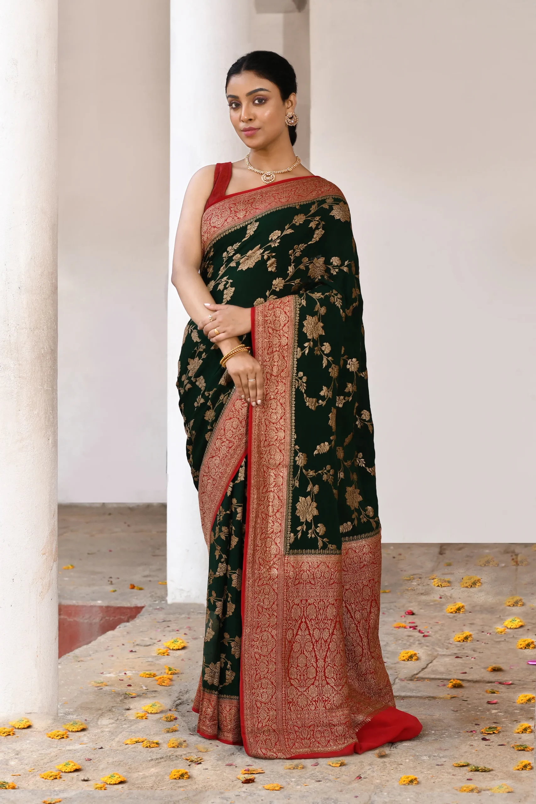 Emerald green Banarasi silk saree with gold zari flower jaal and contrast brown border from Golden Muslin By Naaritva Banaras