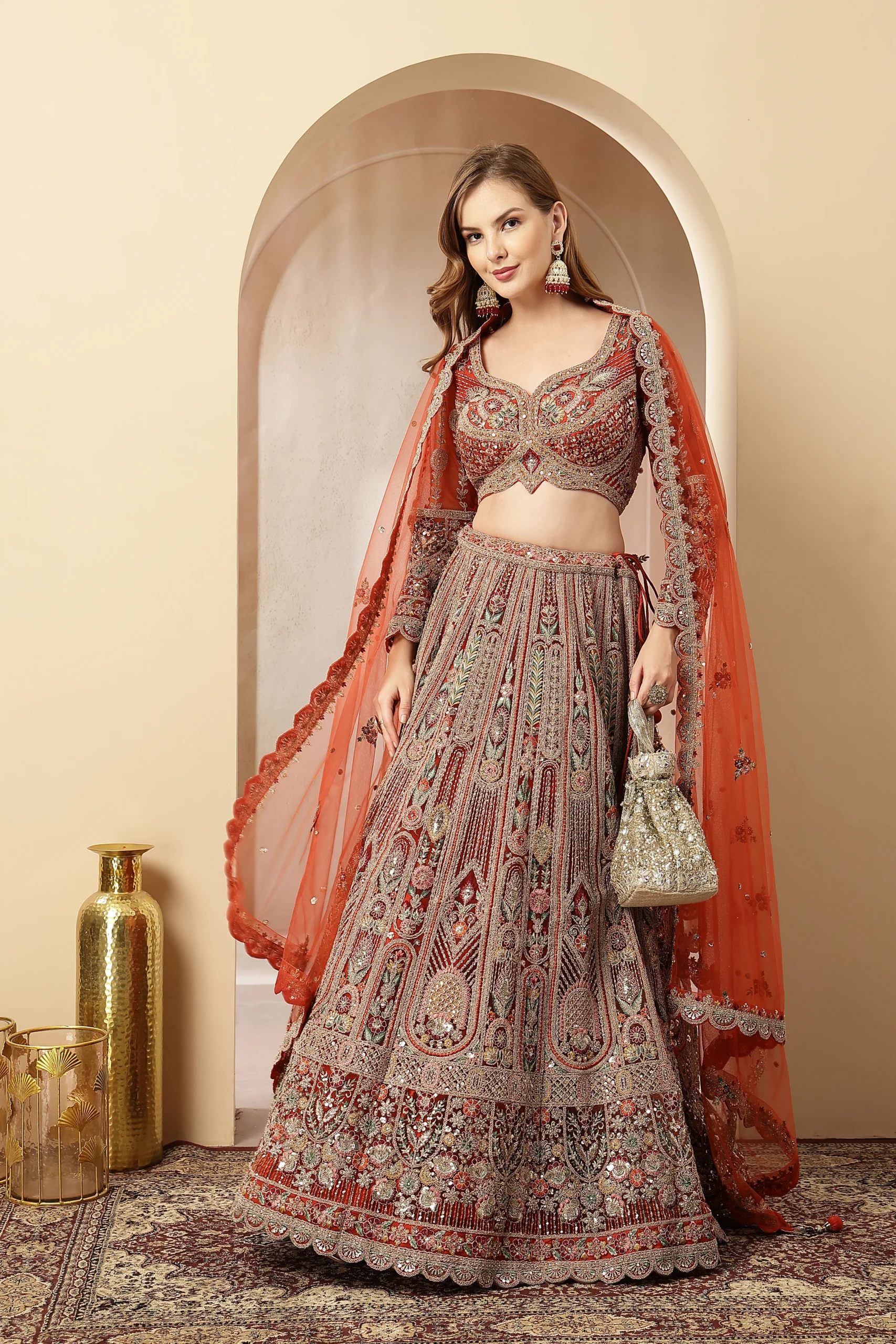 Rust orange embroidered lehenga with net dupatta from Golden Muslin By Soniya G