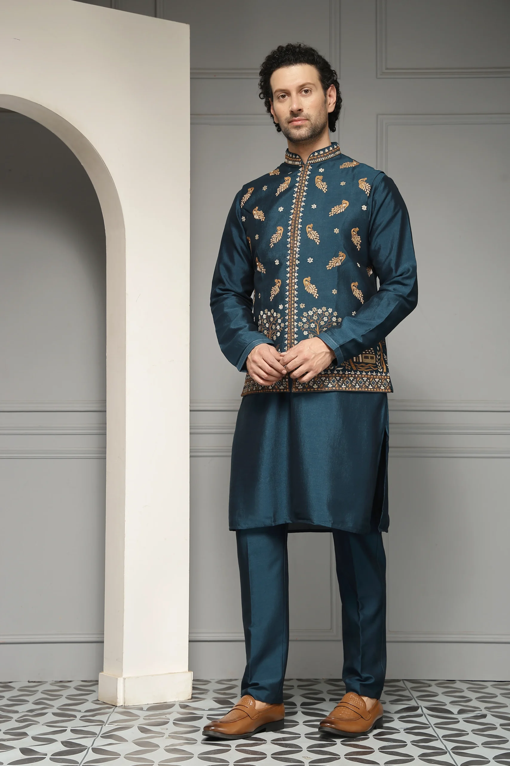 Teal silk-blend kurta set with embroidered Nehru jacket and tailored trousers from Golden Muslin By Soniya G
