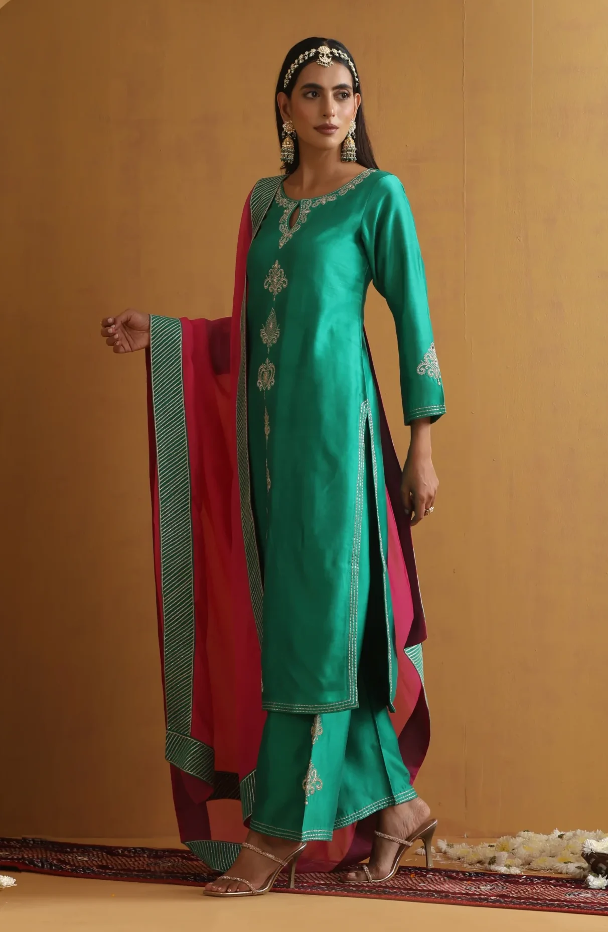 Vibrant teal green embroidered ethnic suit set with contrast dupatta from Golden Muslin By Suikala