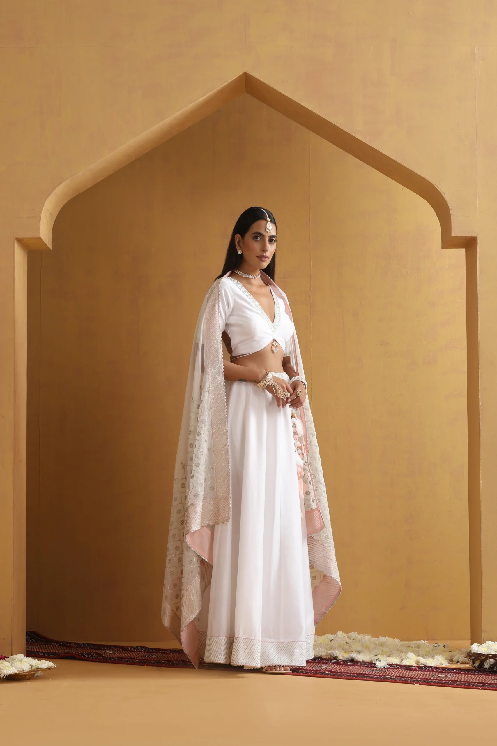 Graceful ivory saree-inspired lehenga ensemble with delicate border from Golden Muslin By Suikala