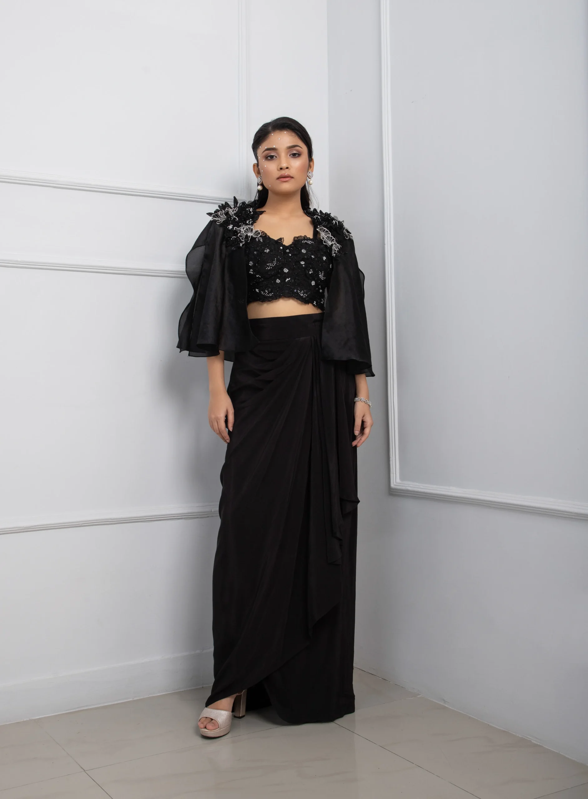 Black Indo Western Cape Set with Organza Floral Applique Cape and Draped Skirt from Golden Muslin By Anuj Agarwal