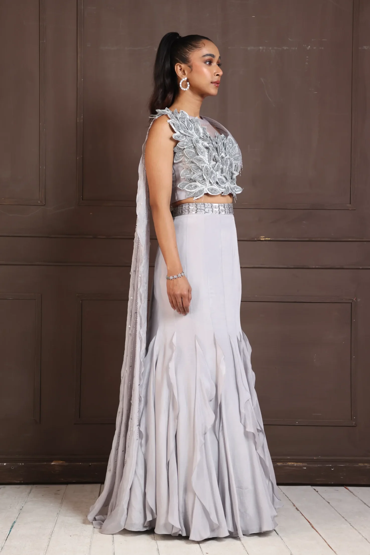 Silver petal embellished lehenga set with 3D floral applique crop top and ruffled lehenga from Golden Muslin By Anuj Agarwal