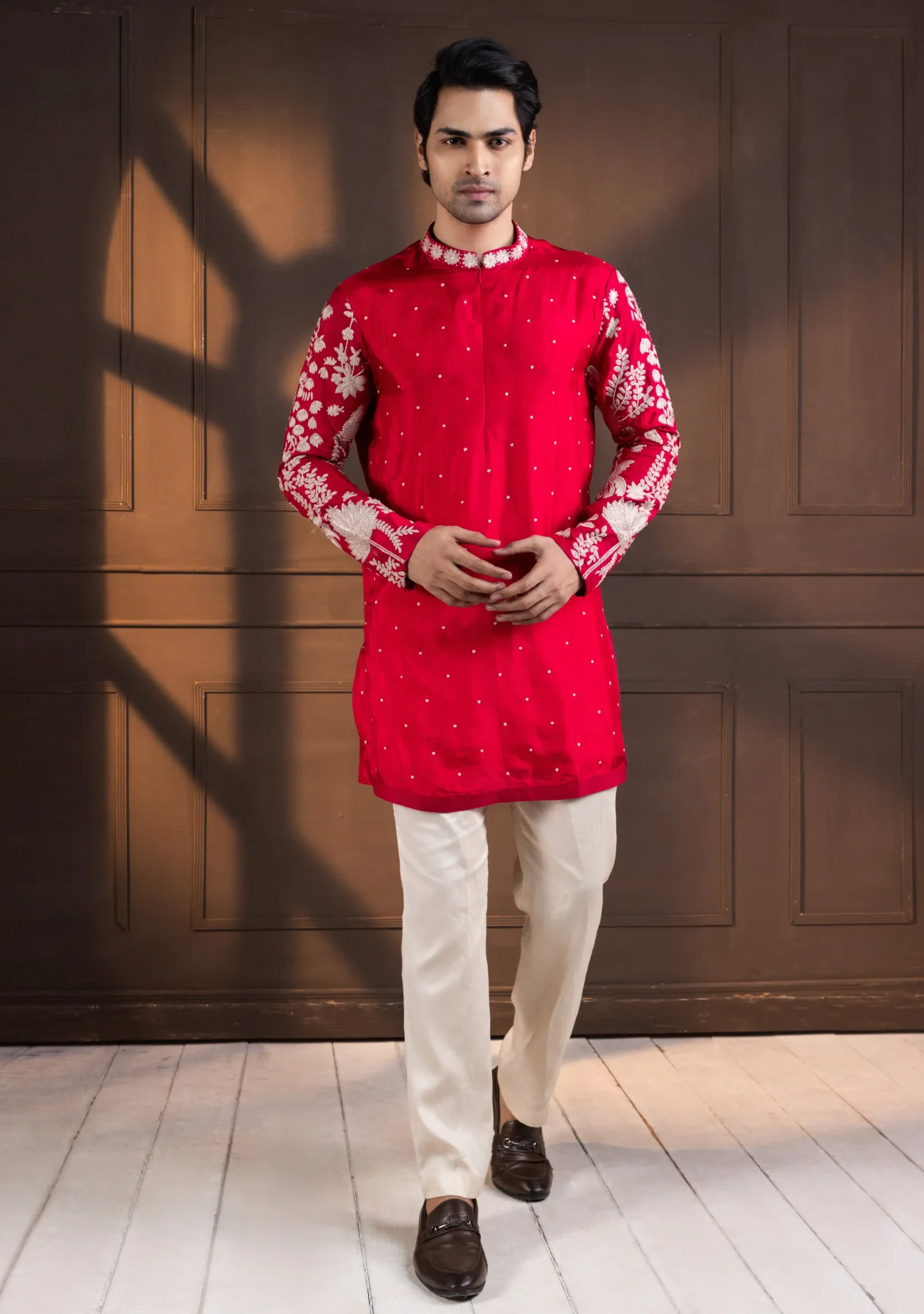 Red embroidered kurta set for men with mandarin collar and ivory floral sleeve motifs from Golden Muslin By Anuj Agarwal