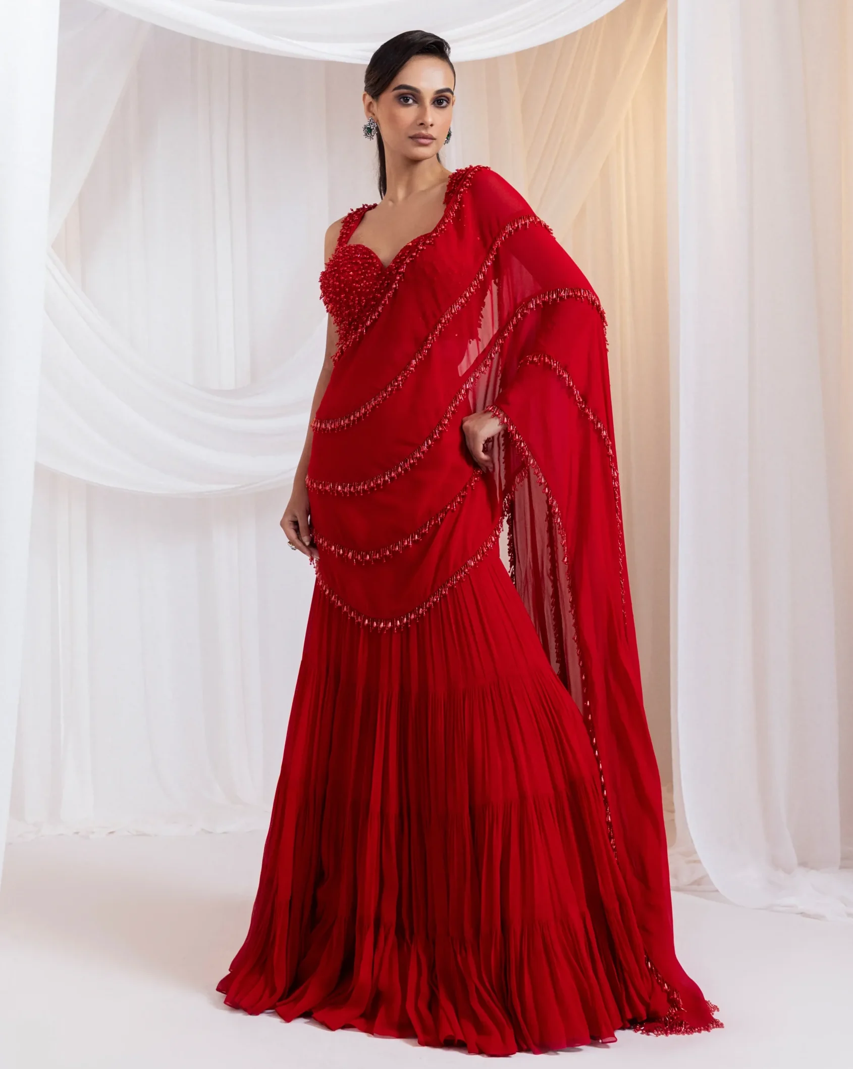 Ruby red drape saree with ruffles and embellished bodice from Golden Muslin By Anuj Agarwal