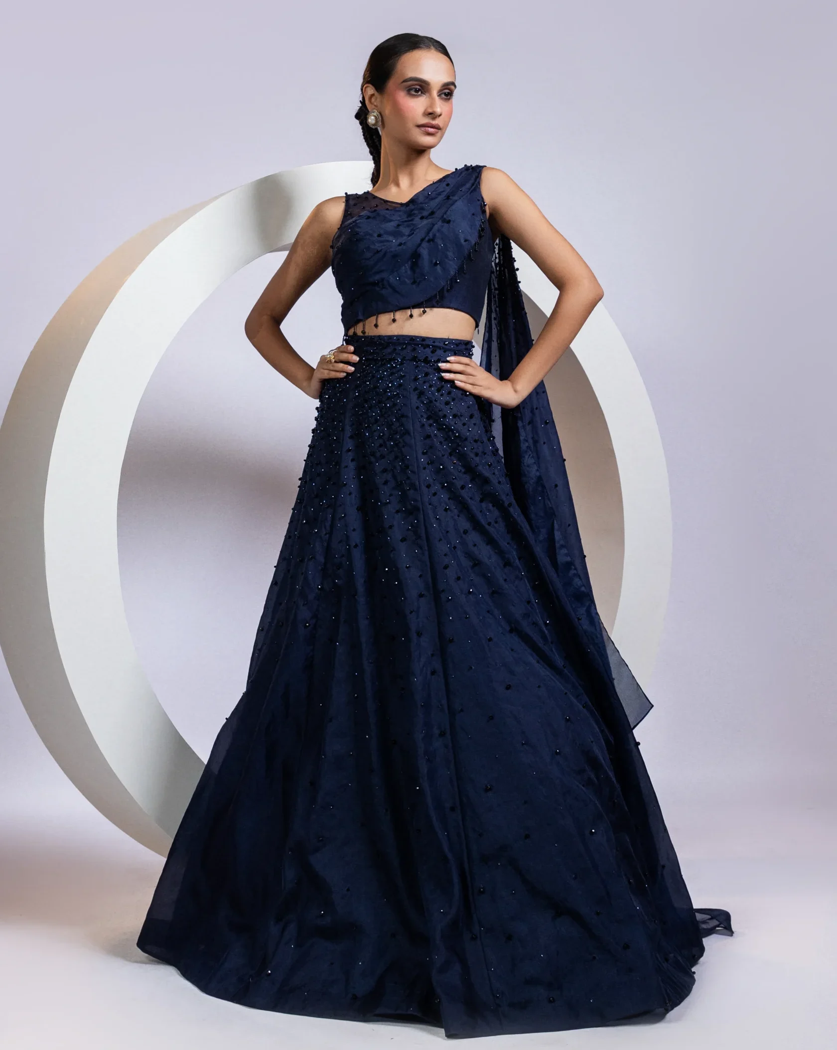 Navy blue drape lehenga set with crystal embellished one-shoulder blouse from Golden Muslin By Anuj Agarwal