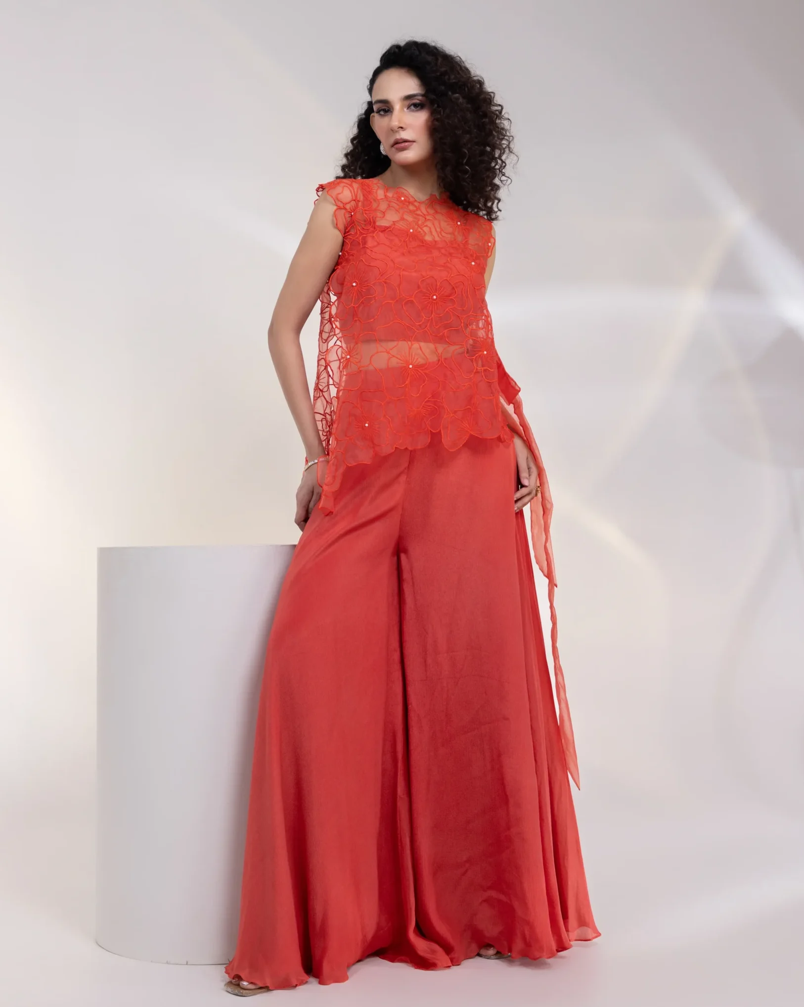 Tomato Red Lace Bodice with Asymmetrical Drape and Wide Leg Trousers from Golden Muslin By Anuj Agarwal