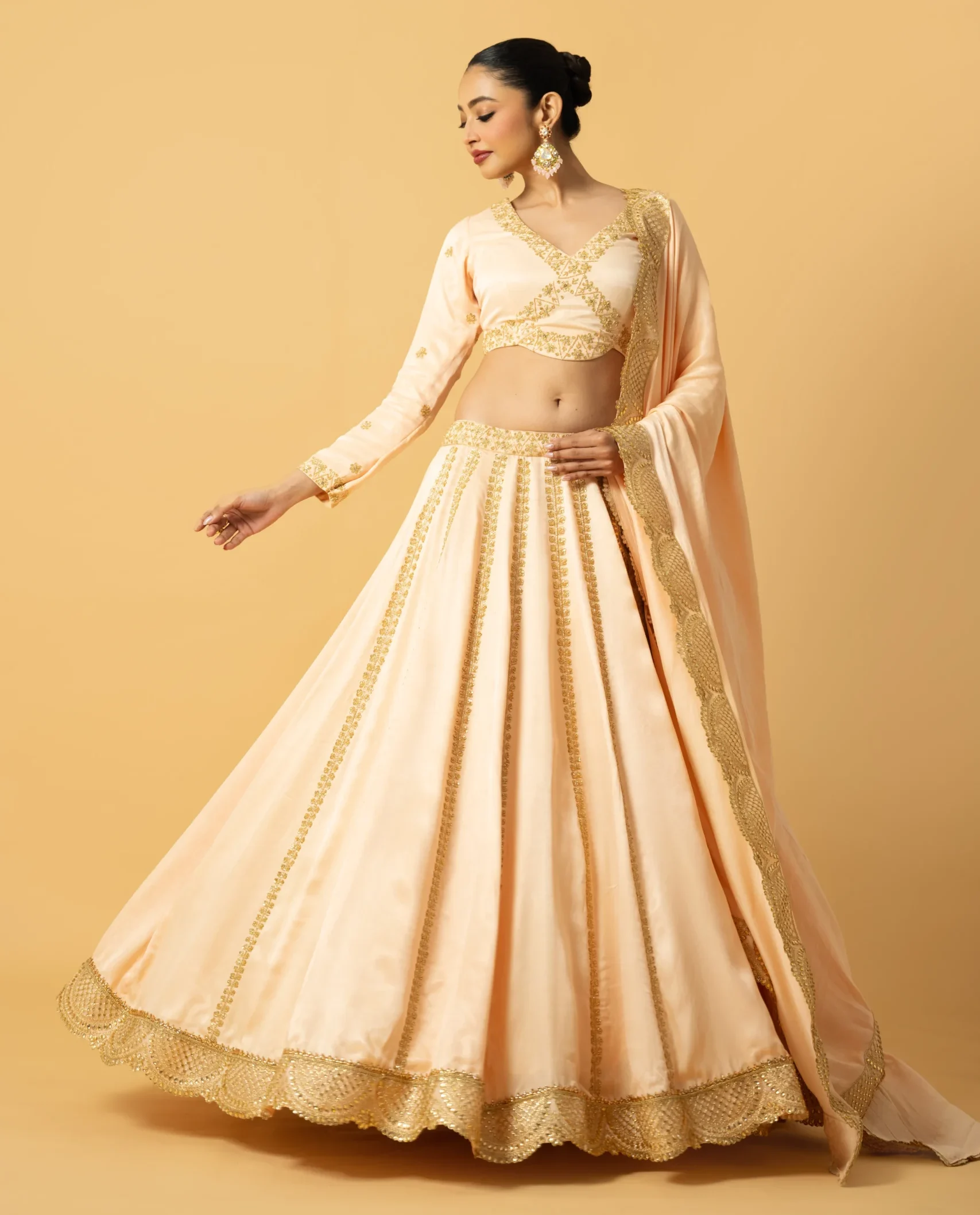 Peach Modal Satin Full Sleeve Lehenga with cutdana and tiki embroidered blouse and lace dupatta from Golden Muslin By Quench A Thirst