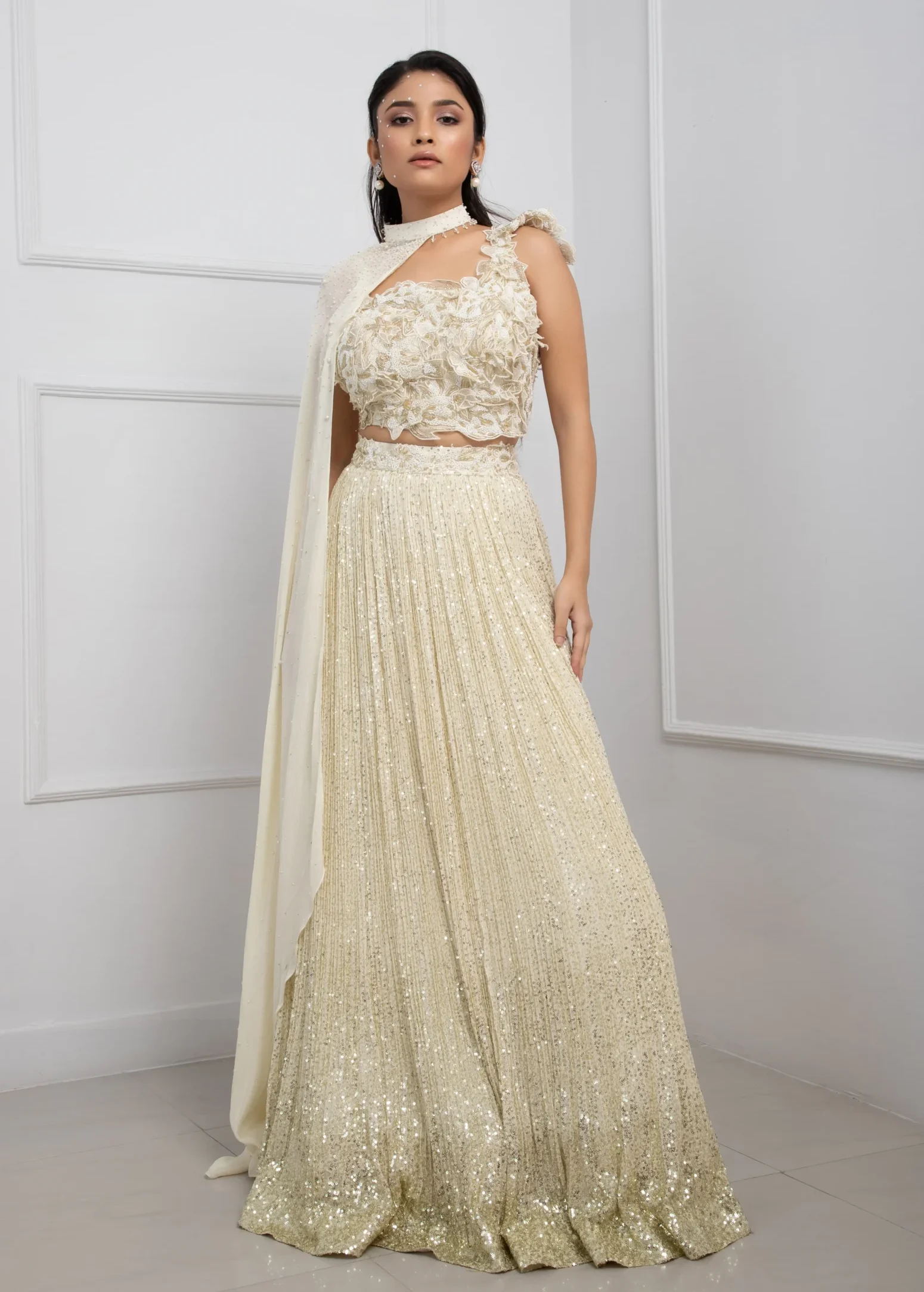 Ivory Chinon Embroidered Lehenga Set with 3D Floral Blouse and Cape from Golden Muslin By Anuj Agarwal