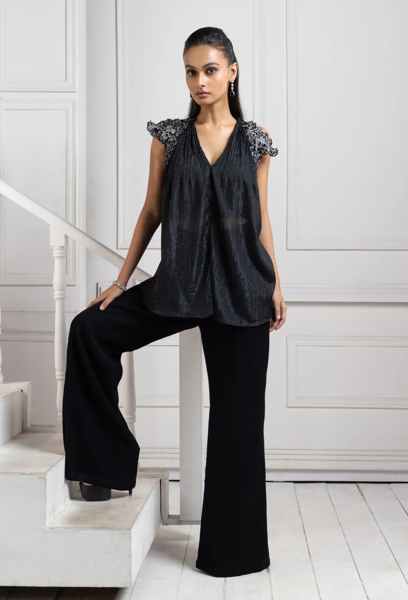 Model wearing black golden muslin modernist textured co ord ensemble with wide leg trousers