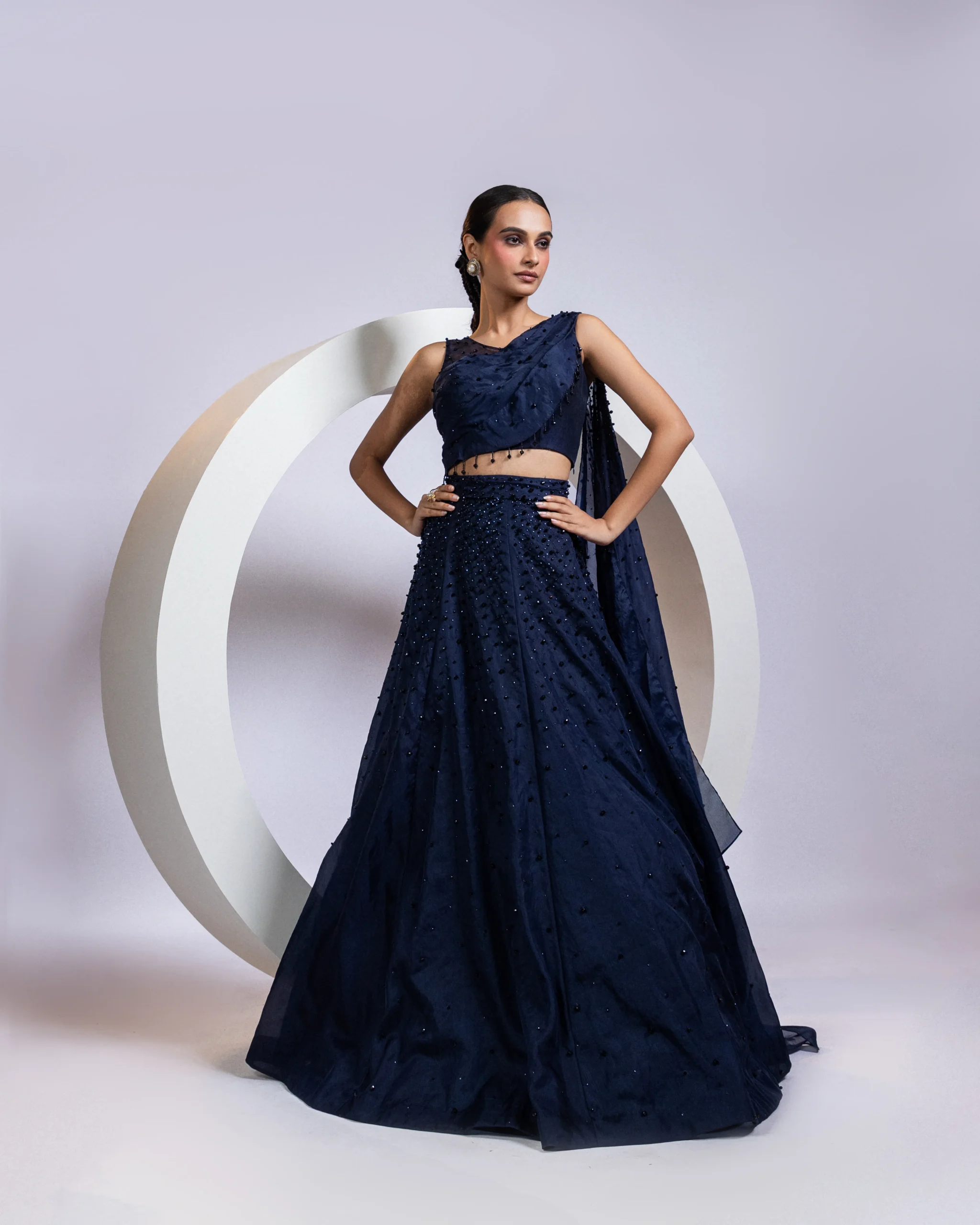 Navy blue drape lehenga set with crystal embellished one-shoulder blouse from Golden Muslin By Anuj Agarwal