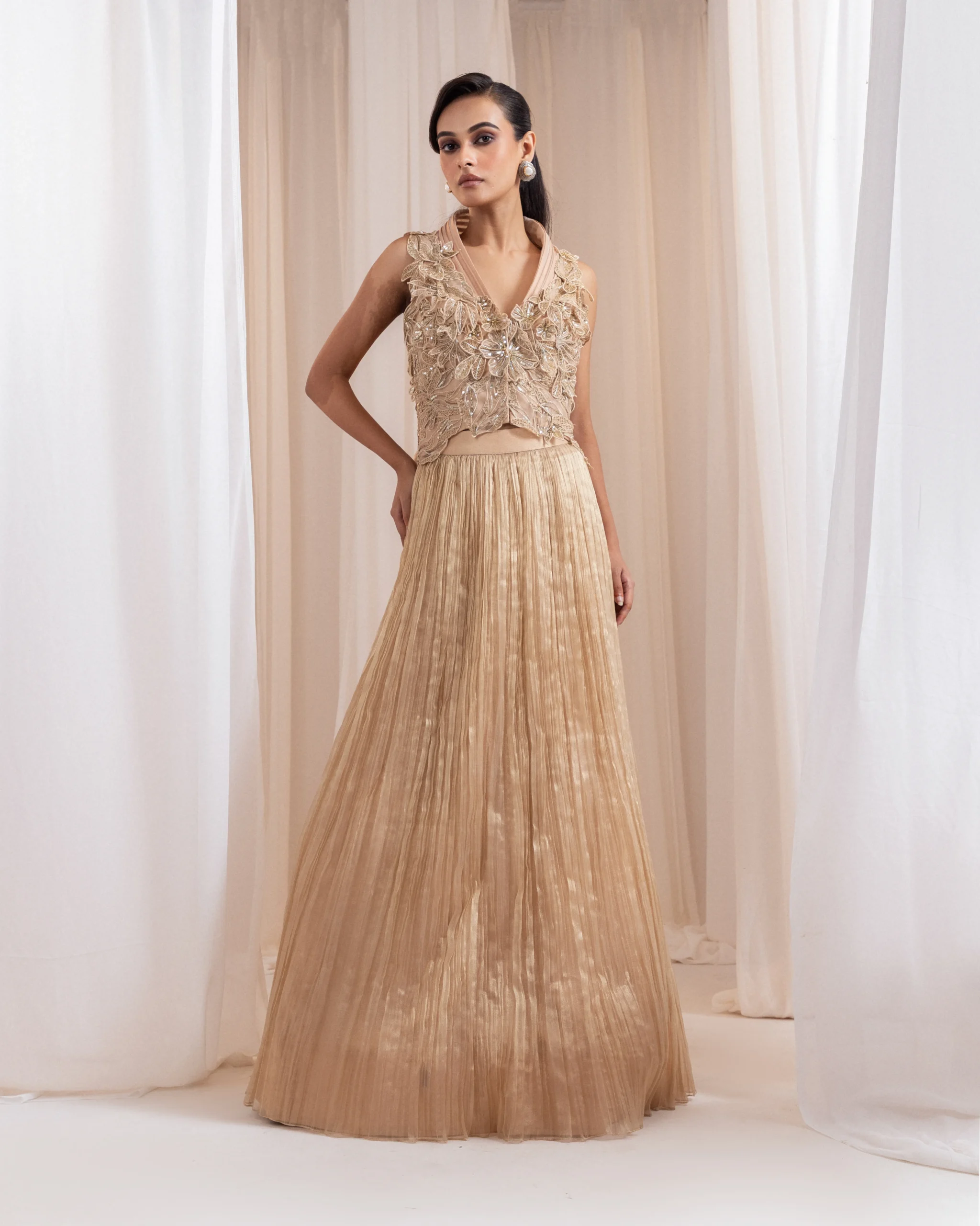 Champagne lehenga set with 3D floral appliqué and pleated net skirt from Golden Muslin By Anuj Agarwal