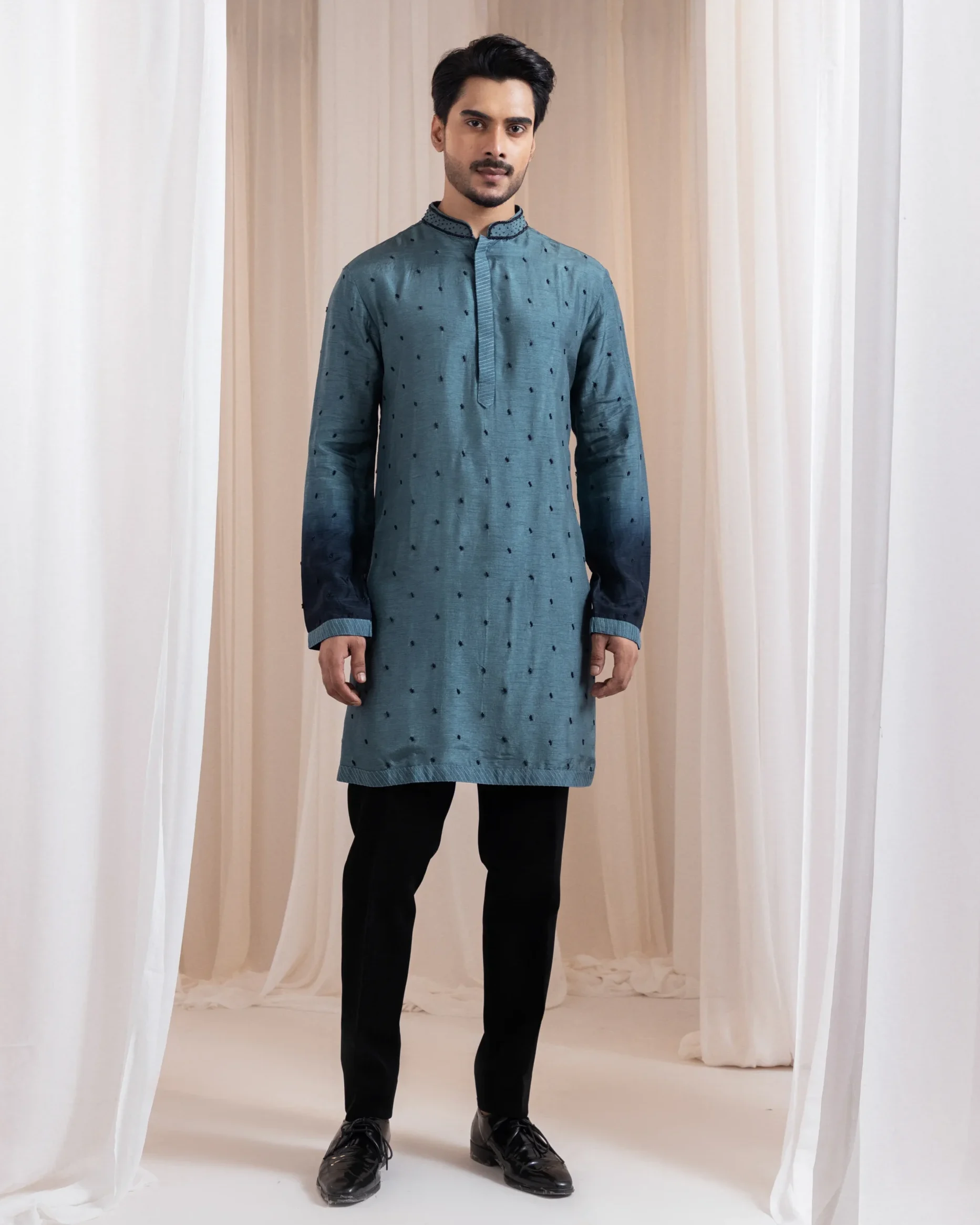 Deep teal two-piece kurta set with gradient cuffs and black bead embroidery from Golden Muslin By Anuj Agarwal
