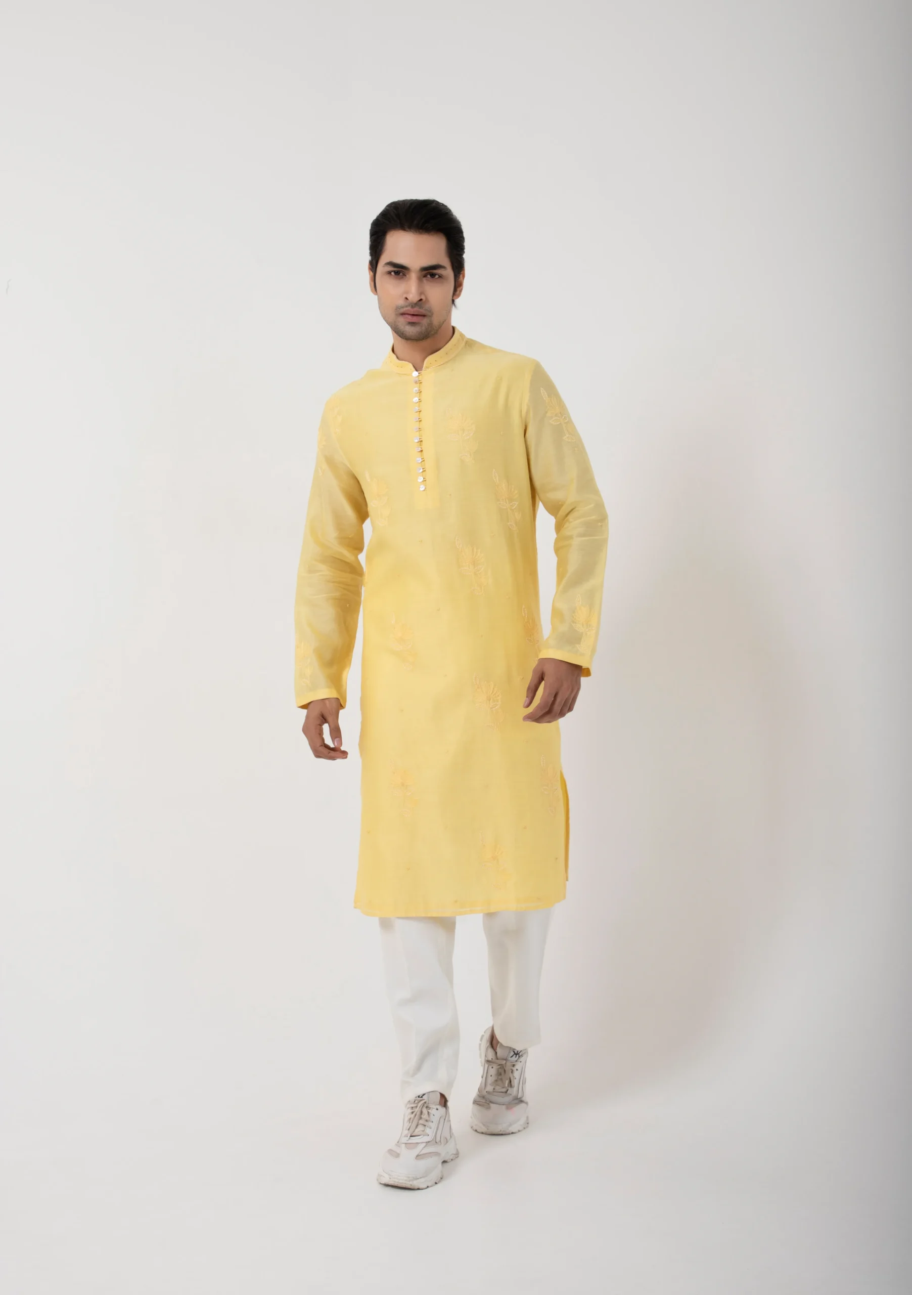 Model wearing butter yellow golden muslin kurta set for men with ivory pant pajama