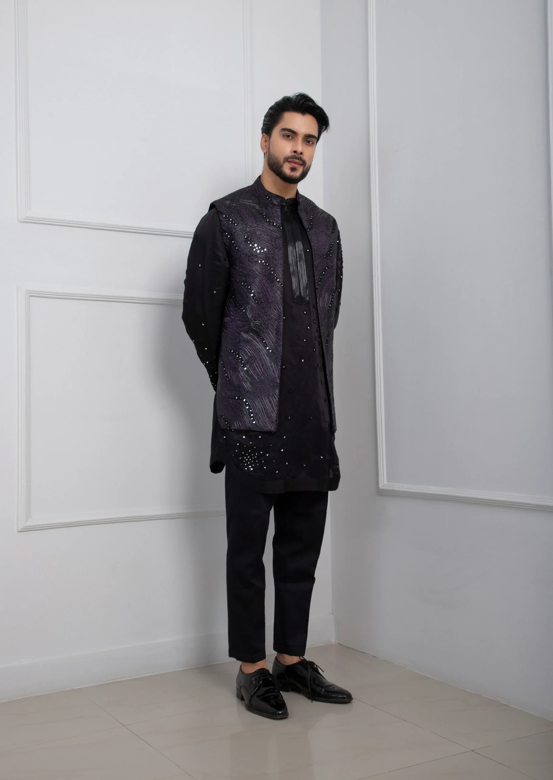 Model wearing dark purple golden muslin Nehru jacket with zipper kurta set and black pants
