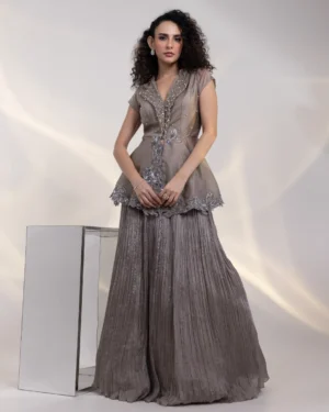Iridescent Peplum Jacket with Floral Embroidery and Pleated Skirt from Golden Muslin By Anuj Agarwal