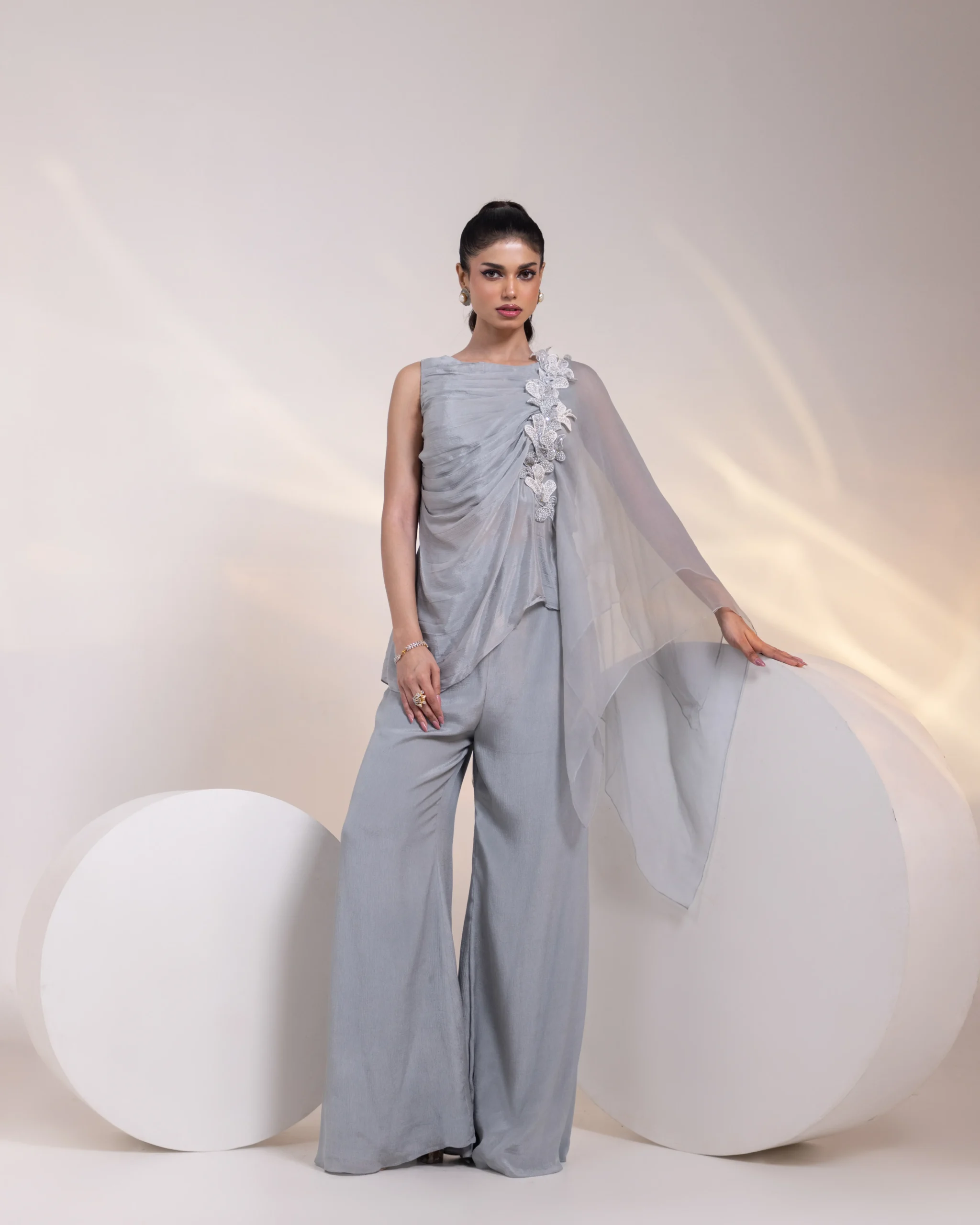 Ash Grey Embroidered Sleeveless Tunic with Organza Shoulder Drape and Wide-Leg Trousers from Golden Muslin By Anuj Agarwal