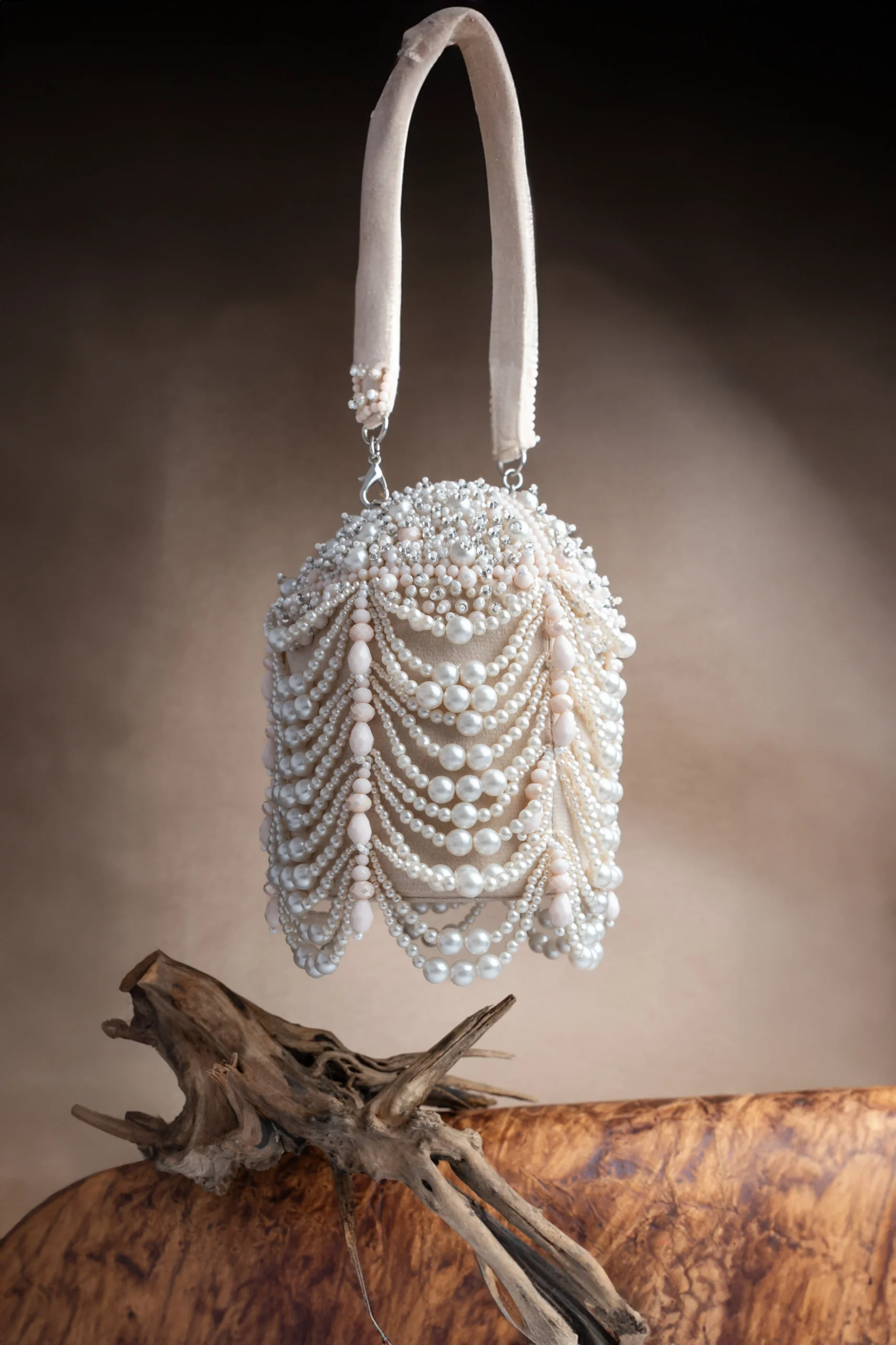 Off White Pearl Scalloped Potli with Tassels and Decorative Lock from Golden Muslin By Nayaab By Sonia featuring pearl scallop detailing and elegant tassels.