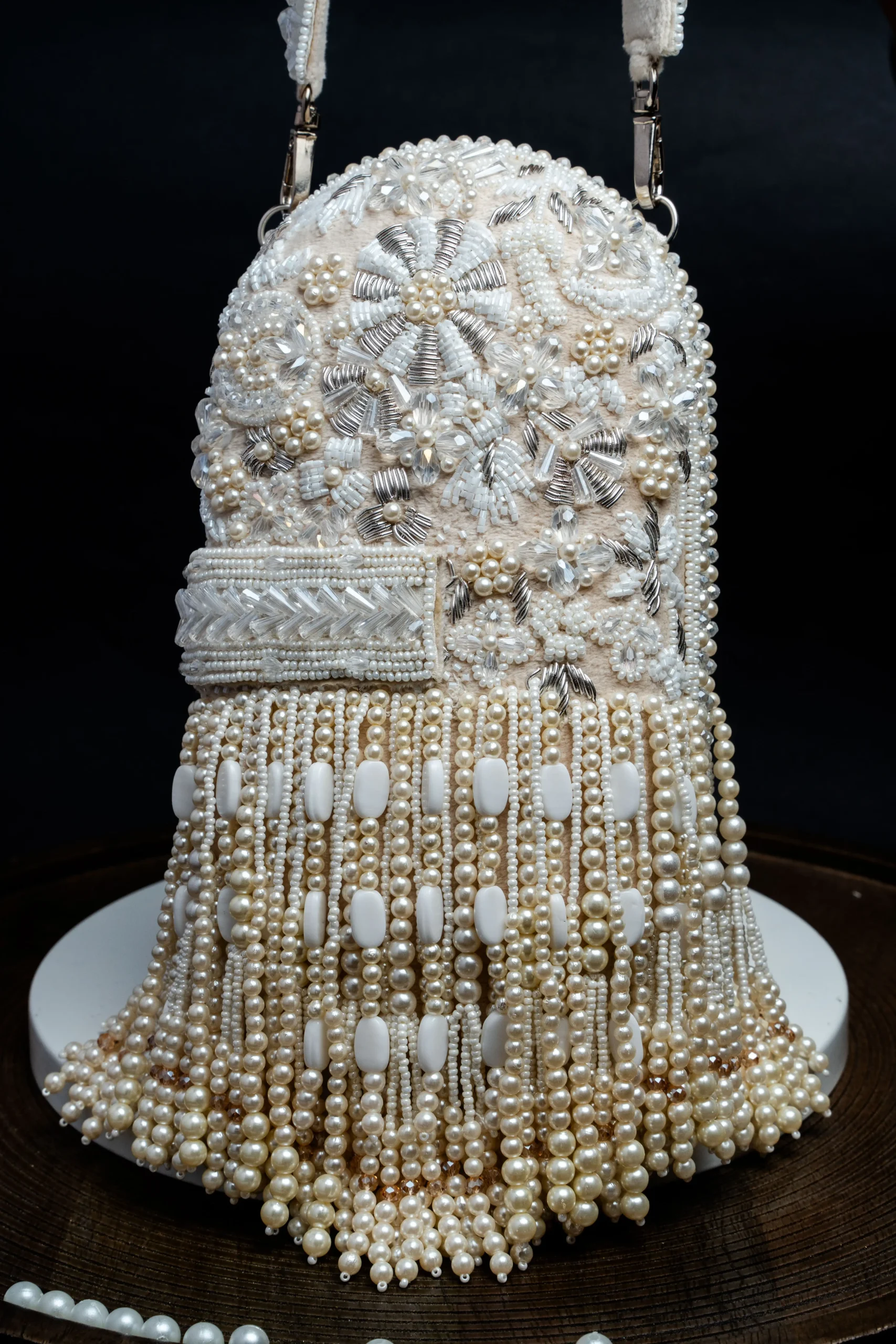 White Beaded Box Clutch with All-Over Tassel Embellishment from Golden Muslin By Nayaab By Sonia featuring intricate beadwork and elegant tassel detailing.